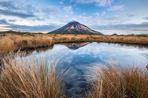 Stratovolcano Mount Taranaki or Mount Egmont reflected in Pouakai Tarn