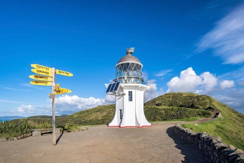 Lighthouse with signposts at Cape Reinga