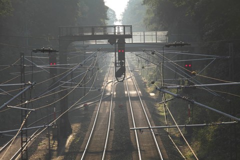 Railroad tracks with signals in morning fog