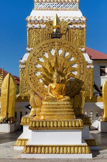 Wheel of Life and Golden Buddha Figure at the Chedi of Wat Mahathat Temple