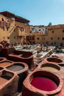 Worker dyeing leather