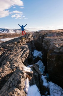Man stands at Continental Rift between North American and Eurasian Plate