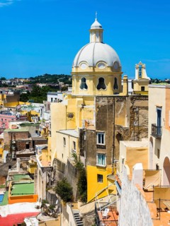 View of the island of Procida with its colourful houses and the church of Santuario S. Maria delle Grazie Incoronata
