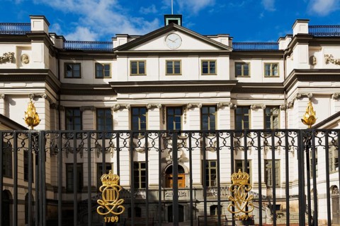 Swedish Supreme Court building with ornate black wrought iron gate with golden crown details