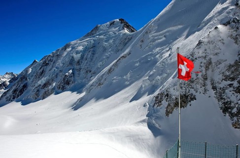 Swiss flag in front of Aletschhorn with snow
