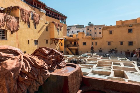 Worker dyeing leather