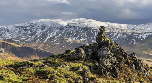 Lava formations and snowy mountains