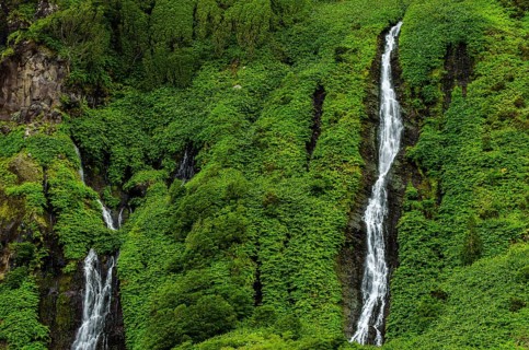 Waterfall Poco Ribeira do Ferreiro in green landscape