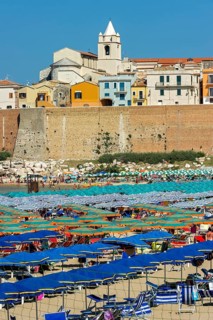 View over the beach to the Old Town with Cattedrale San Basso and Castello Svevo