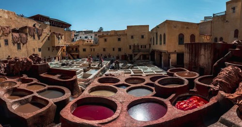 Worker dyeing leather