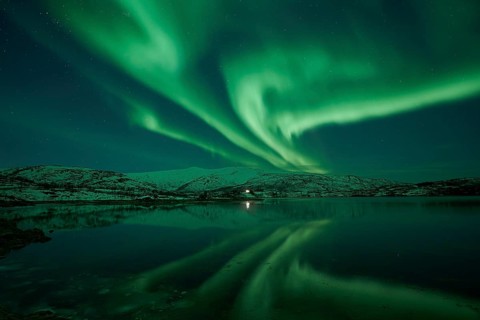 Aurora borealis with water reflection in the fjord
