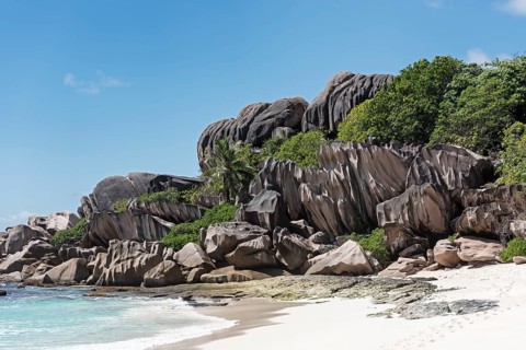 Grand Anse sandy beach with black granite rocks