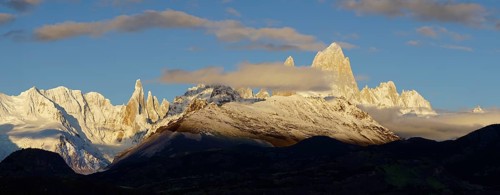Snow-covered mountain range with Cerro Torre and Fitz Roy at sunrise