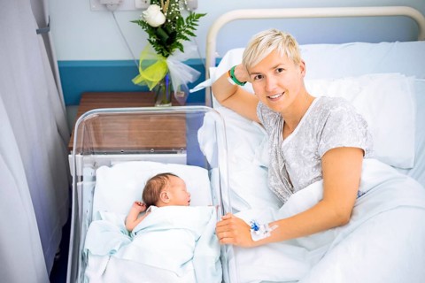 Happy mother enjoying her newborn baby boy still in the hospital