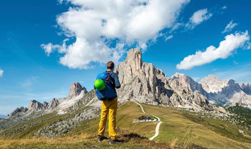 Hiker looking down to Passo Giau