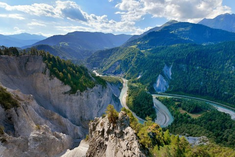 View from the viewing platform Il to the limestone cliffs at a river loop of the Vorderrhein