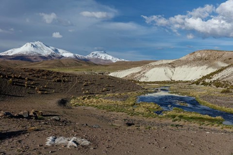 Snow-covered Andean Mountain with mountain river