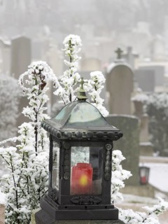 Grave lantern and hoarfrost at the cemetery