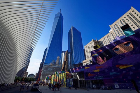 Construction site with graffiti decorated walls in front of the Oculus
