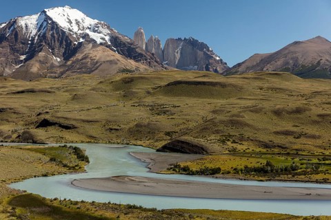 Snow covered peaks of the granite mountains Torres del Paine with the Rio Paine glacial river