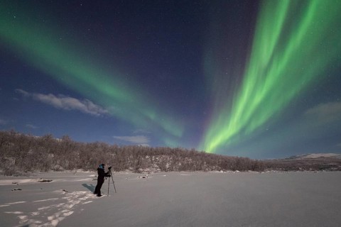 Photographer taking pictures of Northern Lights