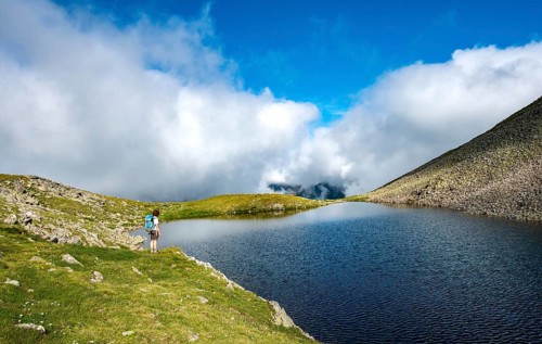 Hiker at Sattelsee lake at Greifenbergsattel