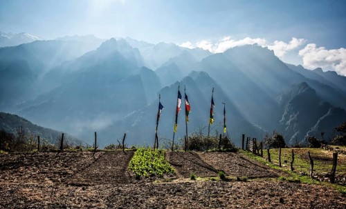 Buddhist prayer flags in front of Himalaya Mountains at sunrise