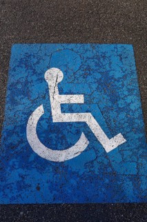 Sign for parking for people with disabilities on torn tar