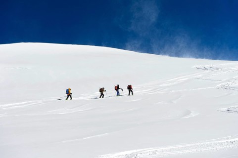 Ski tourers ascending to the summit of Aebeni Fluh