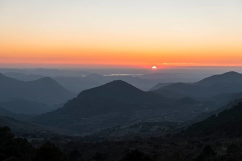 Wooded mountain landscape at sunset