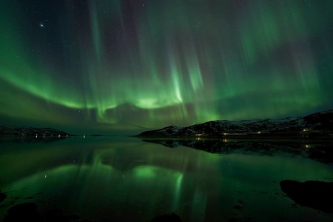 Aurora borealis with water reflection in the fjord