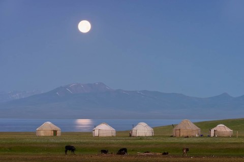 Moon rising over Song Kol lake and nomads Yurts