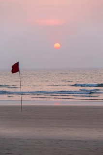 Lifeguard flag in sunset at Agonda Beach