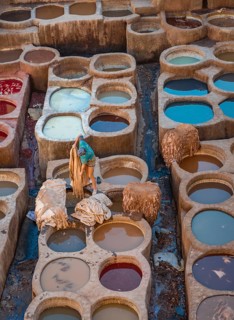 Worker dyeing leather