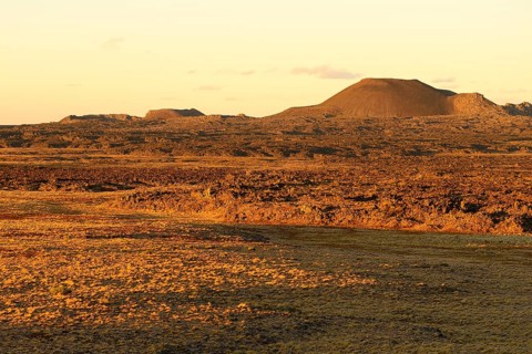 Volcanic landscape with volcanic cones in the evening sun
