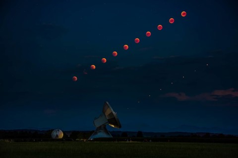 Satellite dish with blood moon and Mars as time lapse