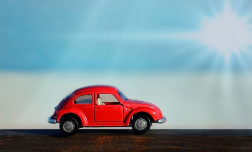 Red toy car with sunbeams