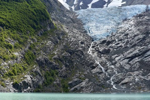 Melting glacier with lake and forest