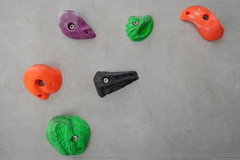 Coloured via ferrules or climbing grips on grey wall