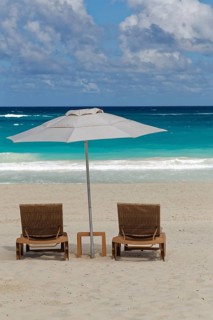 Two beach chairs with parasol on the beach