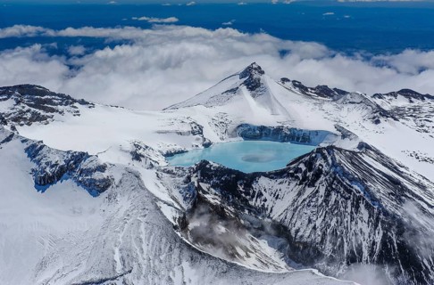 Aerial view of a tuquoise crater lake on top of Mount Ruapehu