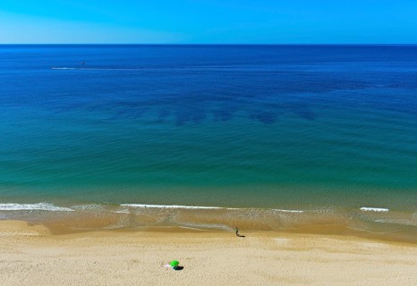Empty sandy beach on the Algarve coast near Praia da Luz