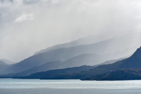 Clouds overhanging mountains at Lake Lago General Carrera (or also Lago Buenos Aires in Argentina)