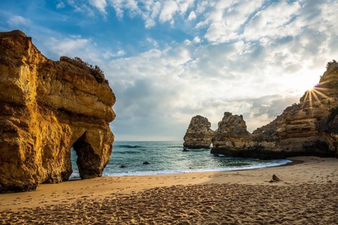 Rocky coast with beach and red rocks