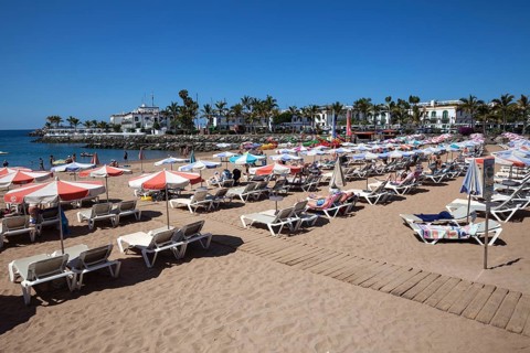 Sandy beach with sun loungers and beach umbrellas