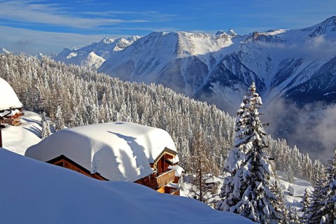 Winter landscape with snow-covered chalet