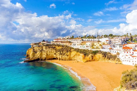 Wide sandy beach and white architecture of charming Carvoeiro