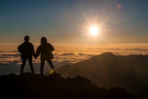 Tourists in backlight waiting for sunset on top of Haleakala National Park