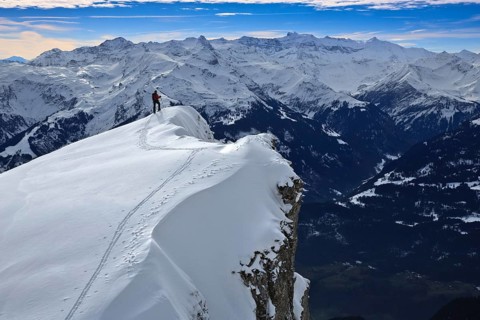 Ski tourers on the snow-covered ridge to the Alvier