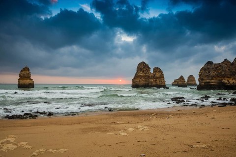 Rocky coast with beach and red rocks